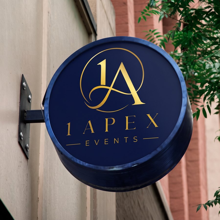 A circular navy 1ApexEvents sign mounted on a building